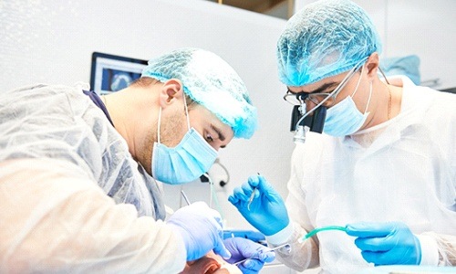 dentists performing dental surgery