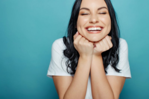 Woman smiling wide after her cosmetic dental treatment